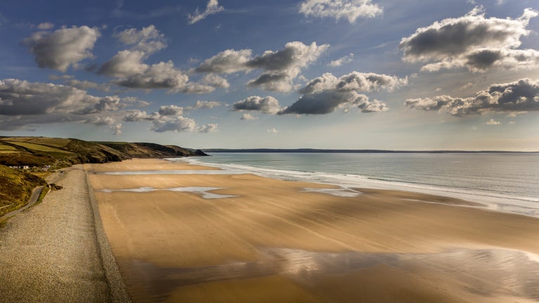 An aerial view of Newgale Beach, two miles of golden sand with pebble bank, Pembrokeshire